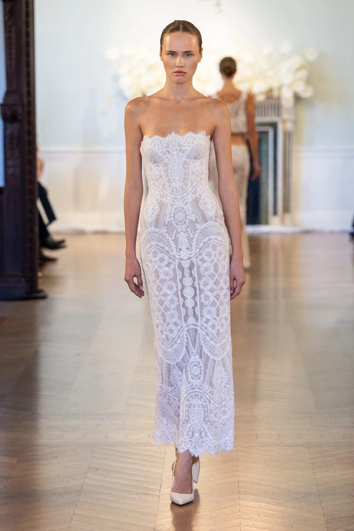 2701 - LEE PETRA GREBENAU - A fitted, immaculately beaded gown featuring a delicate, modern neckline.