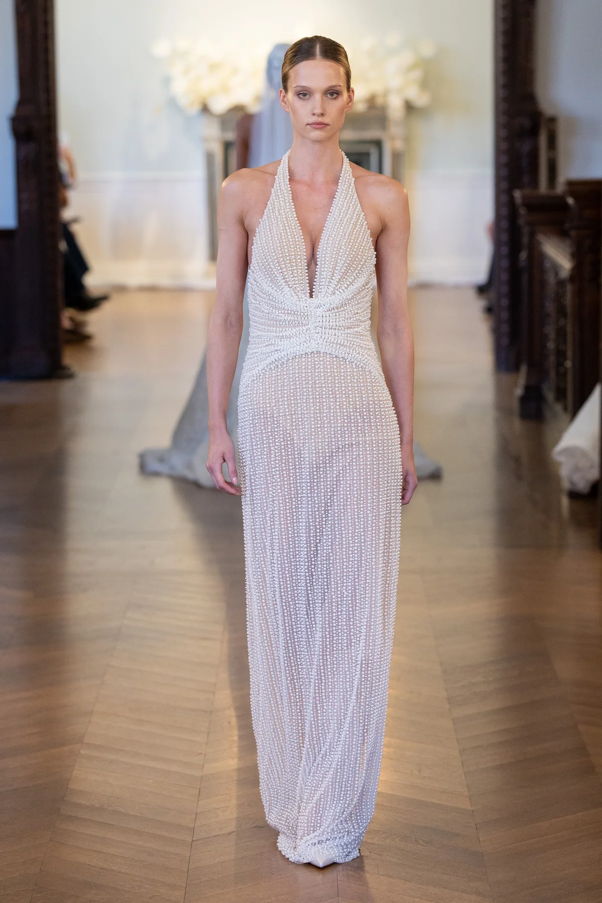 2706 - LEE PETRA GREBENAU - A deep V-neck gown elegantly covered in hand-sewn pearls with a cinched, ruched waist and fitted skirt.