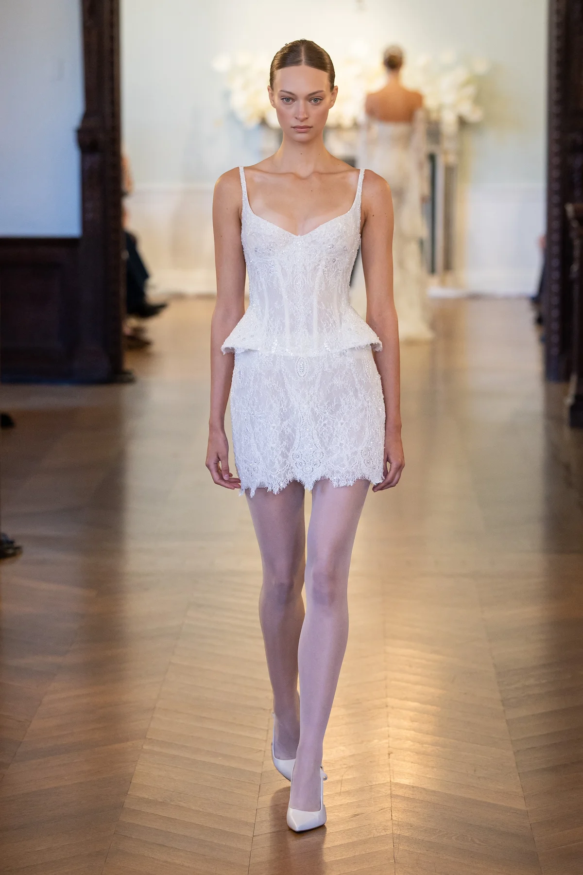 2707 - LEE PETRA GREBENAU - This peplum mini dress is gracefully adorned with extravagant lace embroideries and lace embellishments.