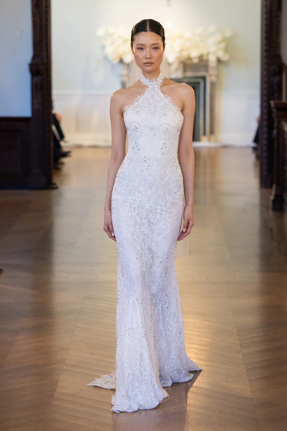 2712 - LEE PETRA GREBENAU - A shoulder-bearing halterneck gown with a fully embroidered, fitted silhouette and a long, delicate train.