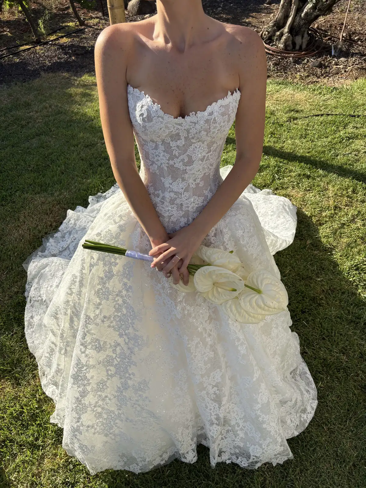 Bride holding a calla lily bouquet on the lawn — Lee Petra Grebenau Talisman lace ball gown