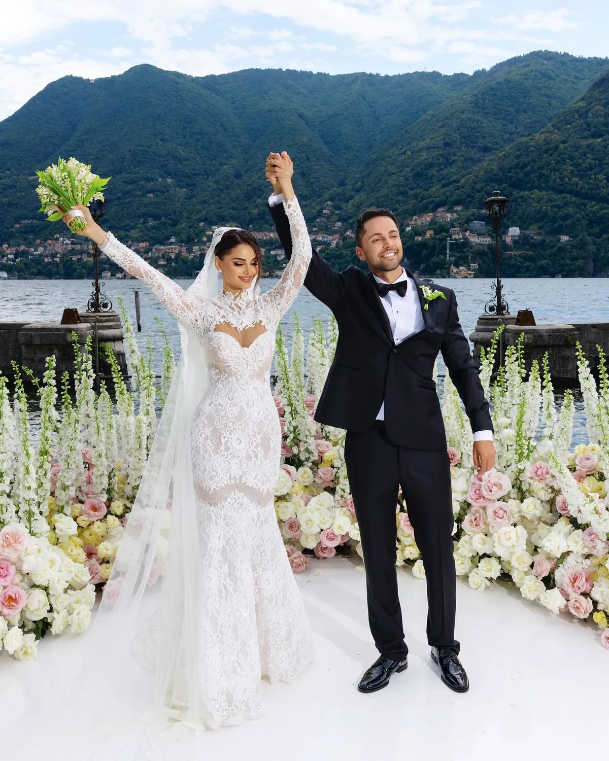 Bride and groom celebrating at the ceremony with arms raised — Lee Petra Grebenau Versailles gown, Villa Erba