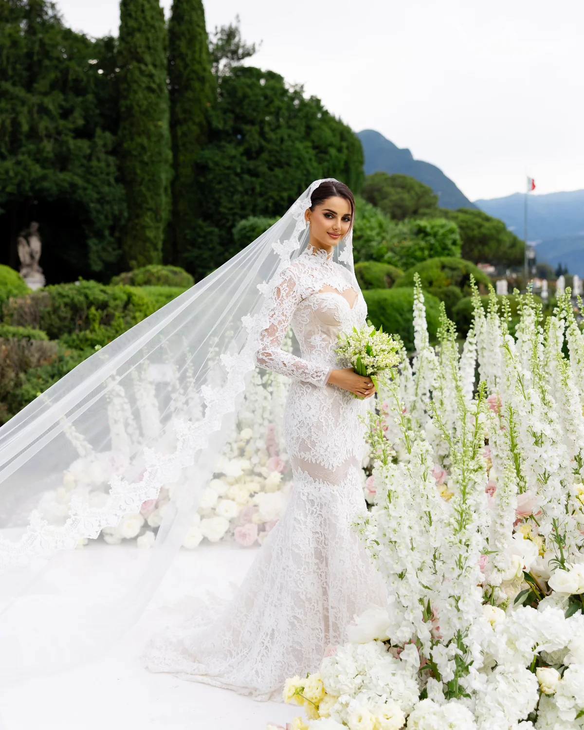 Bride holding a bouquet among white florals at Lake Como — Lee Petra Grebenau Versailles gown