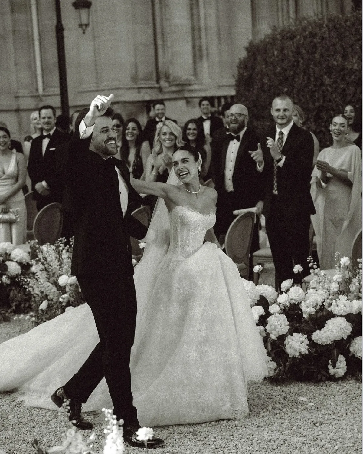Danielle and Spencer celebrating with their guests after the ceremony at the château