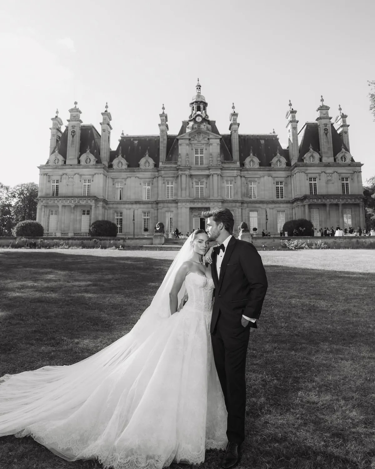 Danielle and Spencer before Château de Saint-Martin-du-Tertre, her cathedral train swept across the lawn