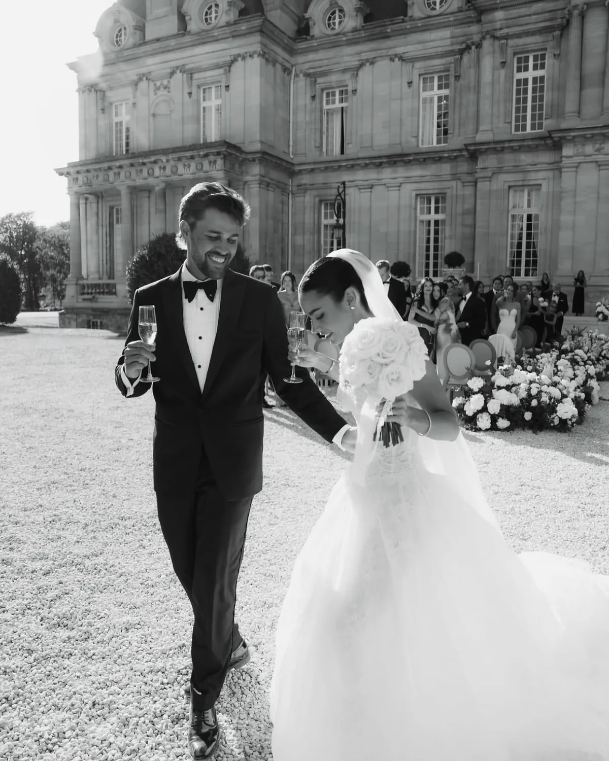 Danielle and Spencer walking together outside the château after the ceremony