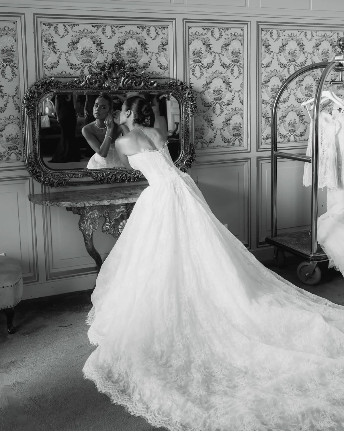 Danielle in her Whisper ball gown before a gilded mirror as she prepares for the ceremony