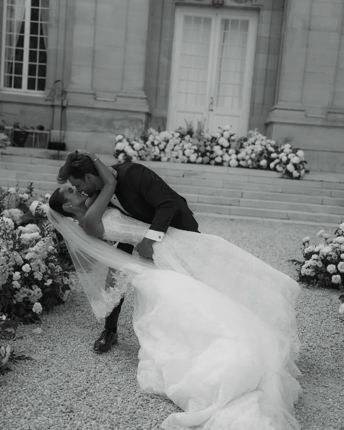 Spencer dipping Danielle for a kiss beside the château steps