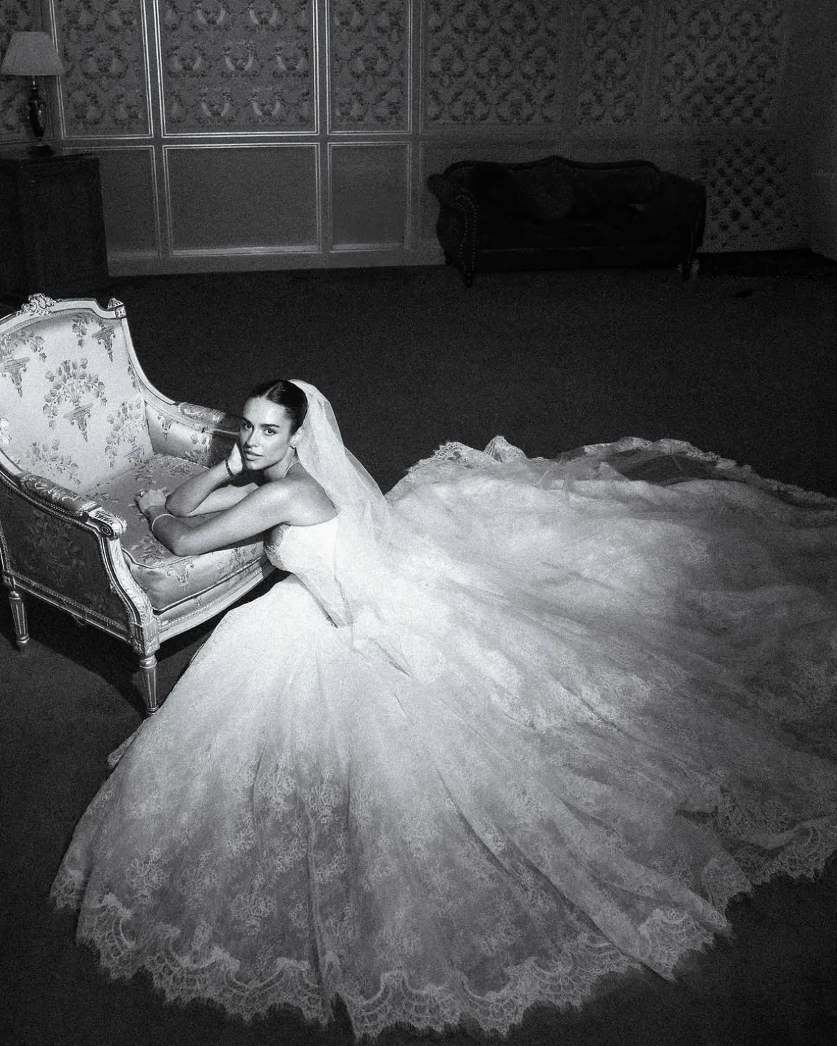 Danielle reclining on an antique settee, the skirt of her Whisper gown spread around her