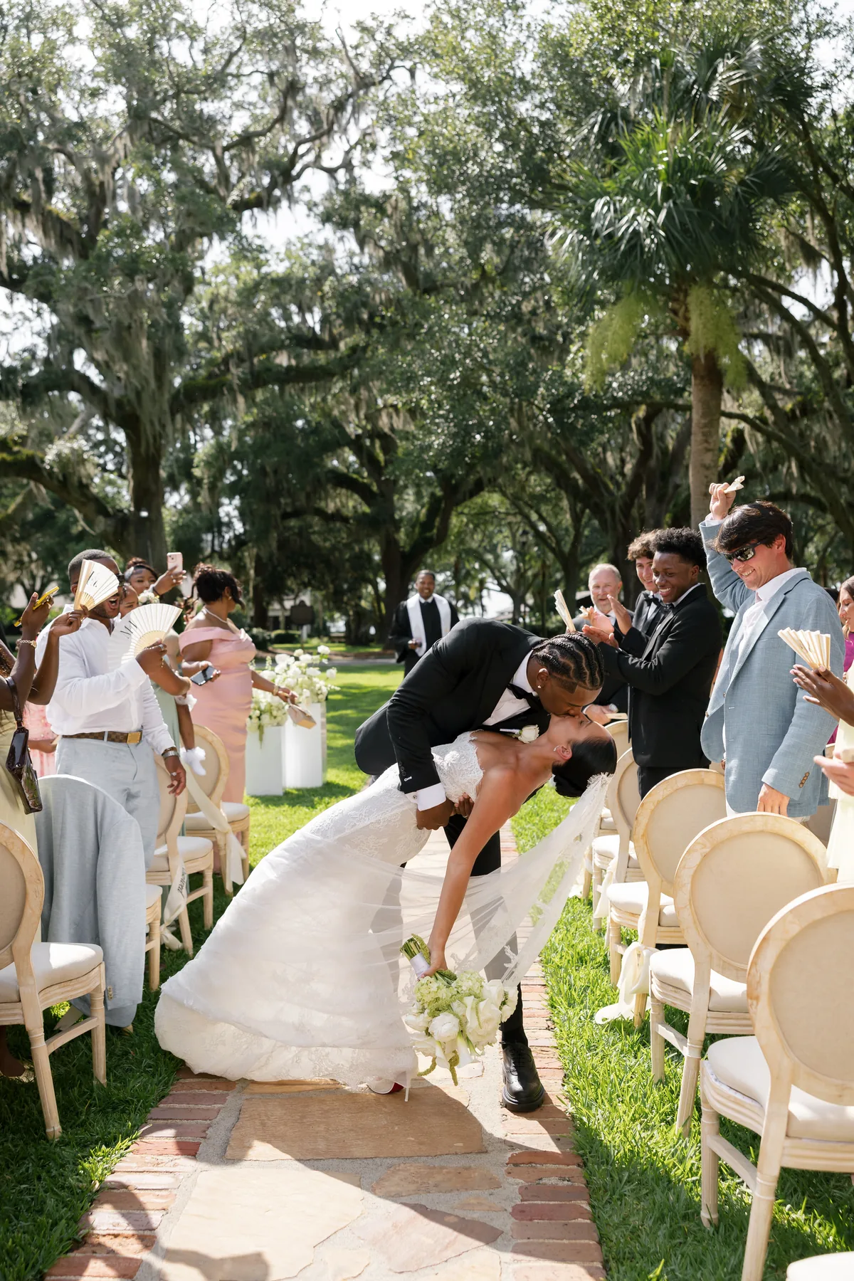 Madison and Jaylin in the aisle, surrounded by their guests after the ceremony